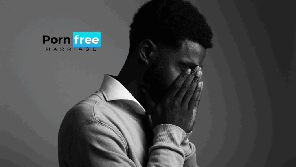 Man with his face in his hand, showing sadness and shame, representing the emotional struggle of porn addiction and the need for recovery.